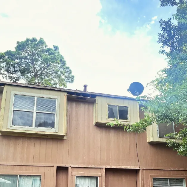 Rebuilt window trim on a two-story