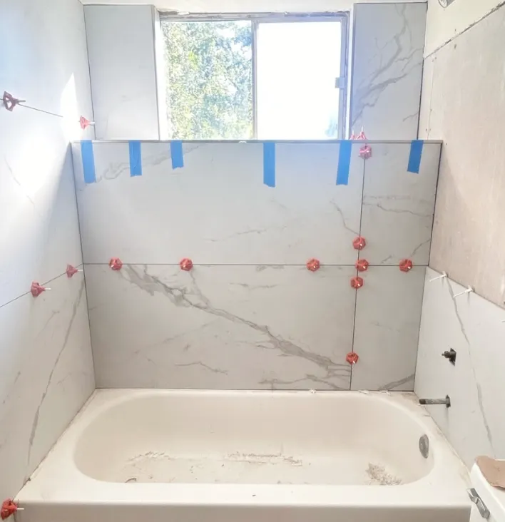 New large-format marble-look tile going up with leveling clips